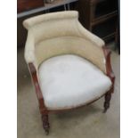 An Edwardian tub chair for re-upholstering having ceramic castors.