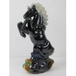 A contemporary lustre painted figuring of a rearing horse, 36cm high.