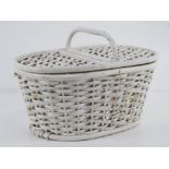 A small white painted vintage picnic basket with loop handle and hinged lid, 33cm wide.