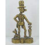 A vintage cast brass doorstop of a large nosed gentleman with hat and umbrella, dog at foot,