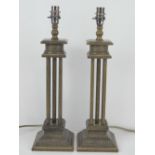 A pair of contemporary table lamps of column form, wired for electricity,