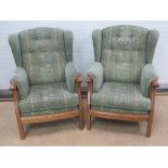 A pair of Ercol high backed arm chairs, bearing original label, approx 75 x 75 x 105cm.