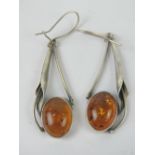 A large pair of Art Nouveau style Baltic amber and silver earrings, 6.1cm drop inc hanger.