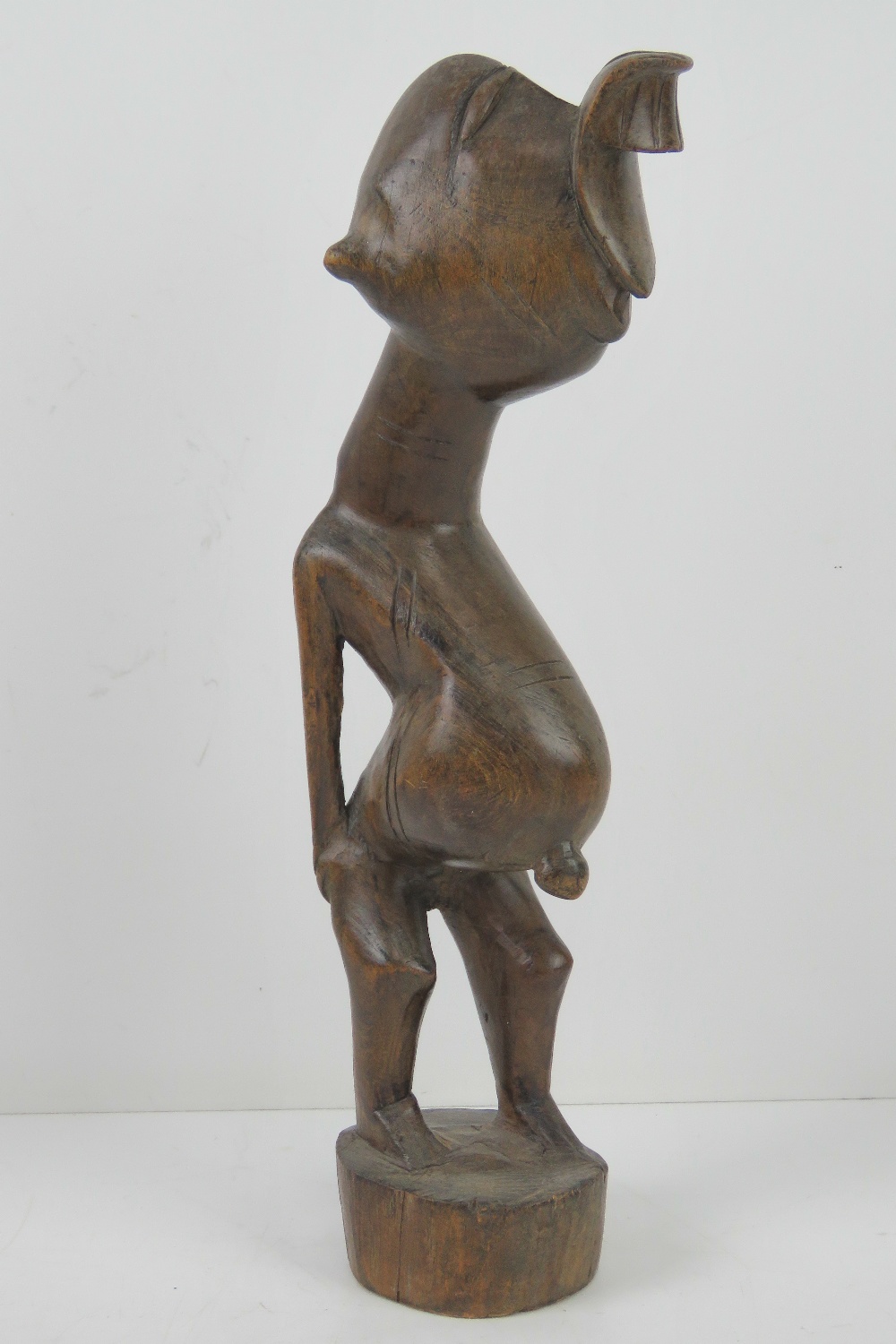 A late 19th / early 20th century carved African fertility figurine standing 31cm high.