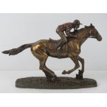 A contemporary bronzed effect sculpture of a race horse with jockey upon, approx 29.