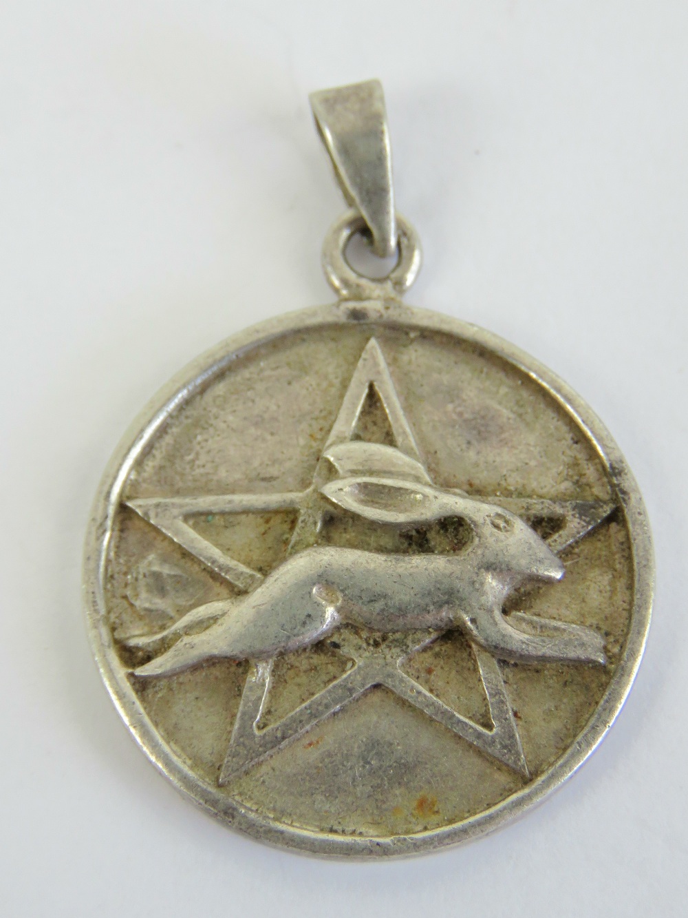 A silver leaping hare and pentagram Wiccan pendant, fertility symbol of Ostara Goddess of Spring,