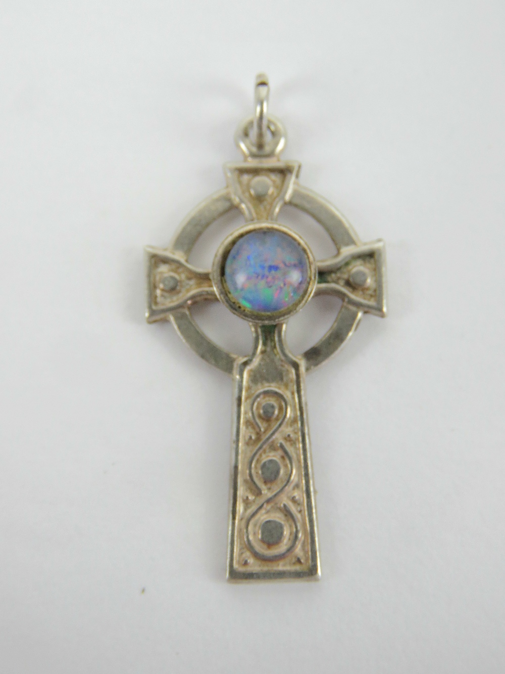 A delightful silver Celtic cross pendant having central opal cabachon, stamped silver, 3.