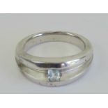 A HM silver ring having central aquamarine to the wide two sectional band, hallmarked for Sheffield,