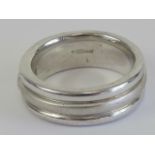 A HM silver ring having three alternating polished and brushed effect band with white stone to