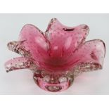 An art glass bowl in the form of a four leaf clover, pink ground, having bubble pattern throughout.