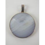 A mother of pearl and silver pendant of circular form, stamped 925, 3.8cm dia.