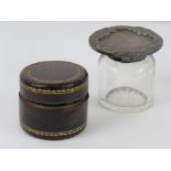 A leather and brass travelling inkwell opening to reveal captive sprung lid and glass bottle within
