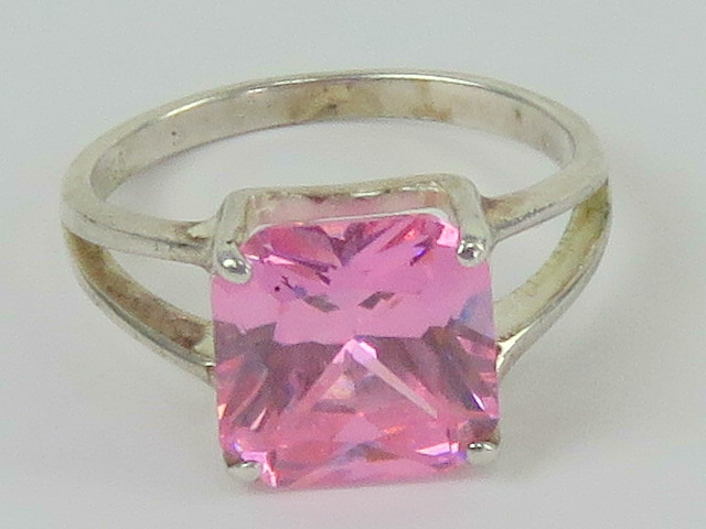 A silver and pink stone cocktail ring, the large square cut stone in claw setting,s tamped 925,