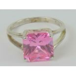 A silver and pink stone cocktail ring, the large square cut stone in claw setting,s tamped 925,