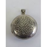 A large HM silver Celtic locket having Irish blessing and knot design upon 'May the road rise to