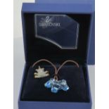 A Swarovski crystal pendant in the form of a dog complete with cord necklace and box.