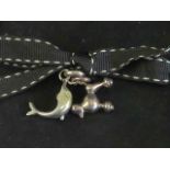 Links of London; two silver charms having Links hallmark upon in the form of a dolphin and a poodle.