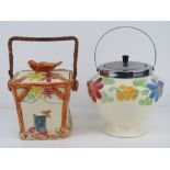 Two hand painted wafer / biscuit barrels in a floral design.