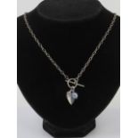 An HM silver necklace having T-bar clasp with heart shaped tag and foiled glass beads upon,