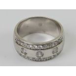 A silver ring designed by Zinzi, the wide band (9mm) set with cz stones,
