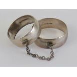 An unusual pair of HM silver Bohemian style 'slave rings' attached by chain,