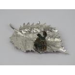 An unusual and superbly made HM silver ornament in the form of a gilded rabbit upon a leaf,