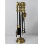A brass and black painted metal fireside companion set comprising stand, brush, pan,