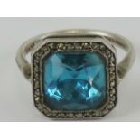 A silver, marcasite and blue stone cocktail ring, size K-L.