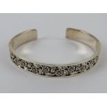 An HM silver bangle having floral decora