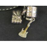 Links of London; three silver charms having Links hallmark upon in the form of a guitar,