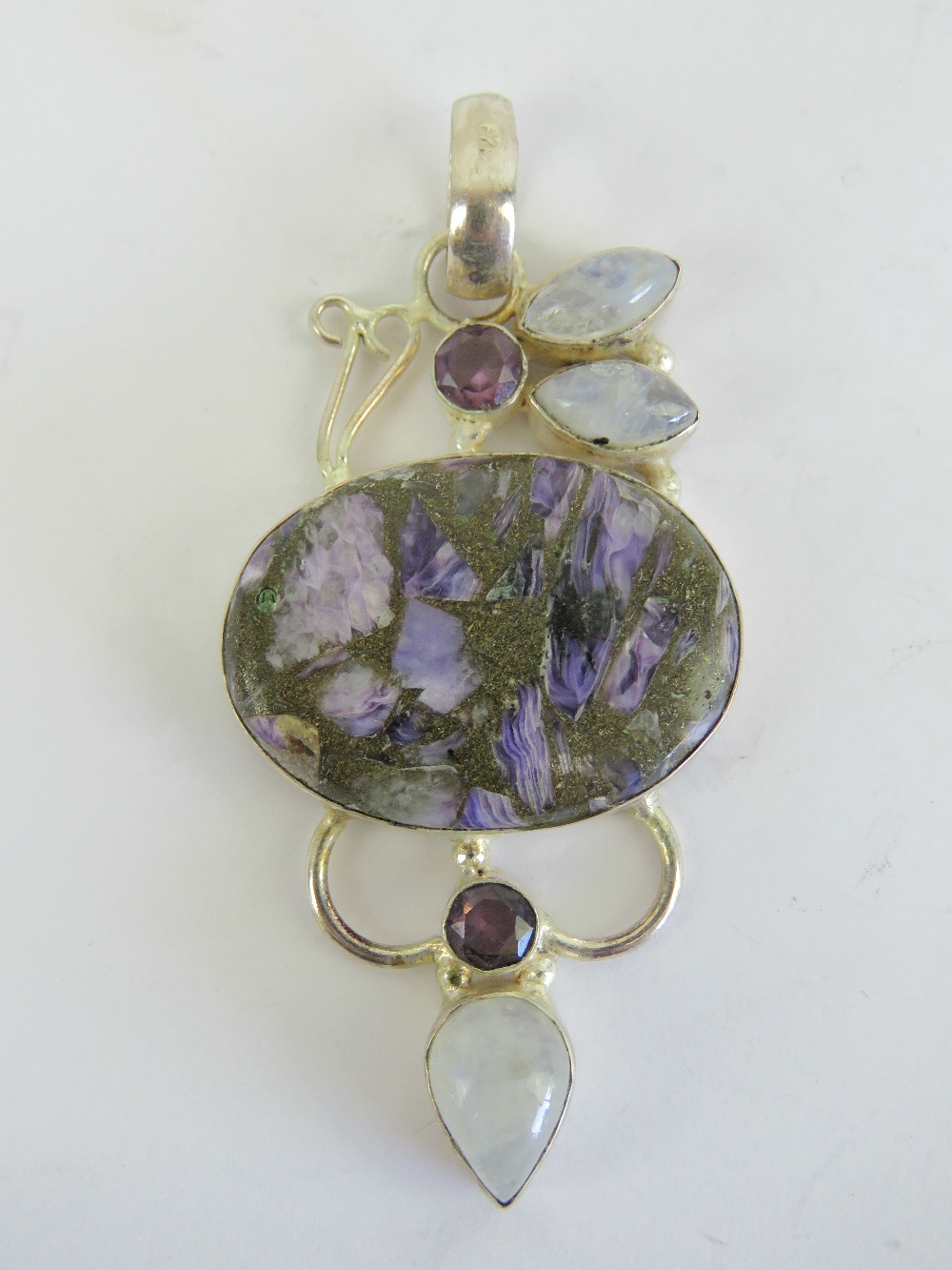 A large and impressive purple agate pendant having moonstone and amethyst coloured stones in