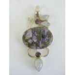 A large and impressive purple agate pendant having moonstone and amethyst coloured stones in