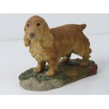 A figurine of a Golden Cocker Spaniel be