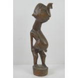 A late 19th / early 20th century carved African fertility figurine standing 31cm high.