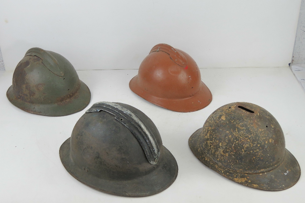 Four WWI/WWII French helmets.