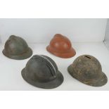 Four WWI/WWII French helmets.