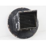 A WWII US headlamp blackout cover for a