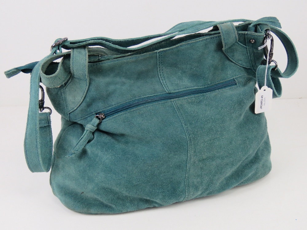 A vintage turquoise blue suede handbag.