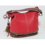 A red and brown Paula Rossi handbag with