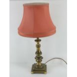 A brass table lamp having pink silk shade, all standing 68cm high, for re-wiring.