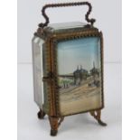 A late Victorian pocket watch holder, French made with bevelled glass and ormolu having painting
