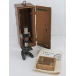 A Britex Pioneer II microscope in box with instructions and set of six slides.