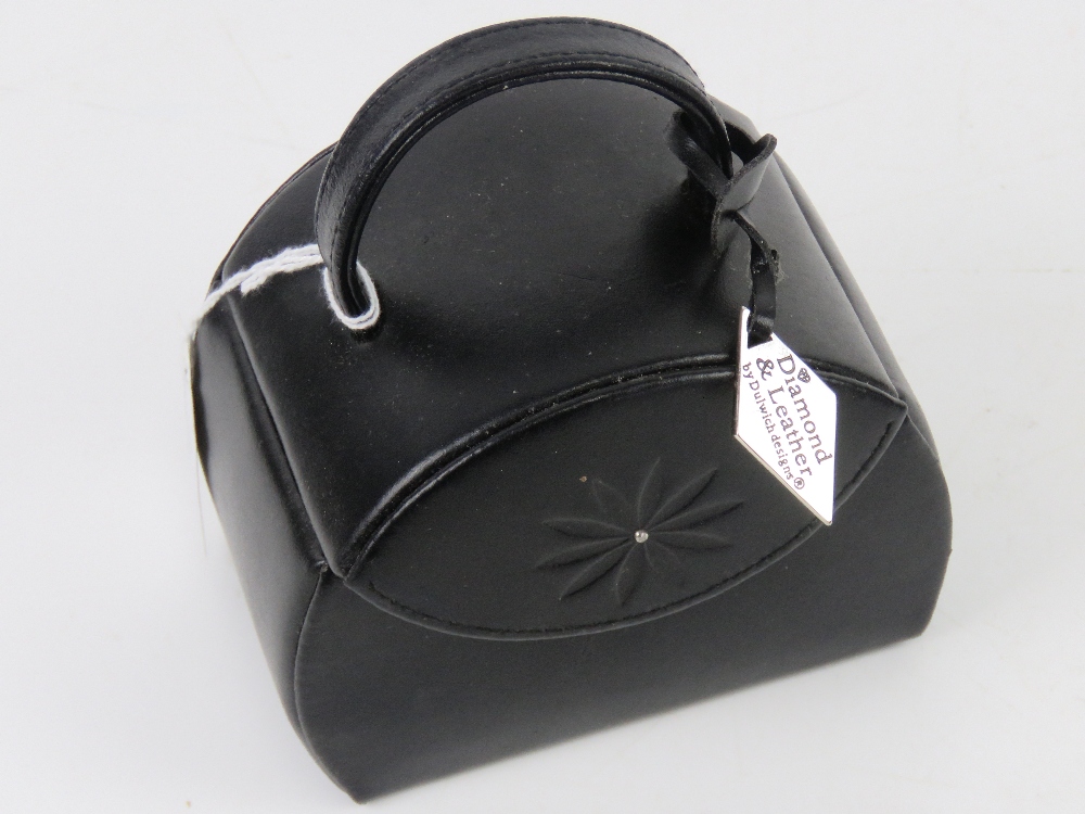 A contemporary black leather jewellery case having various compartments within. 12 x 8 x 13cm.