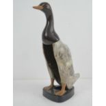 A c1960s clothes brush in the form of a plasticised standing duck, 28cm high.