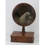 An unusual mahogany gentleman's shaving mirror having drawer under and adjustable round mirror