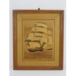 A large marquetry picture of a masted ship with sails on the sea, framed and glazed, overall size