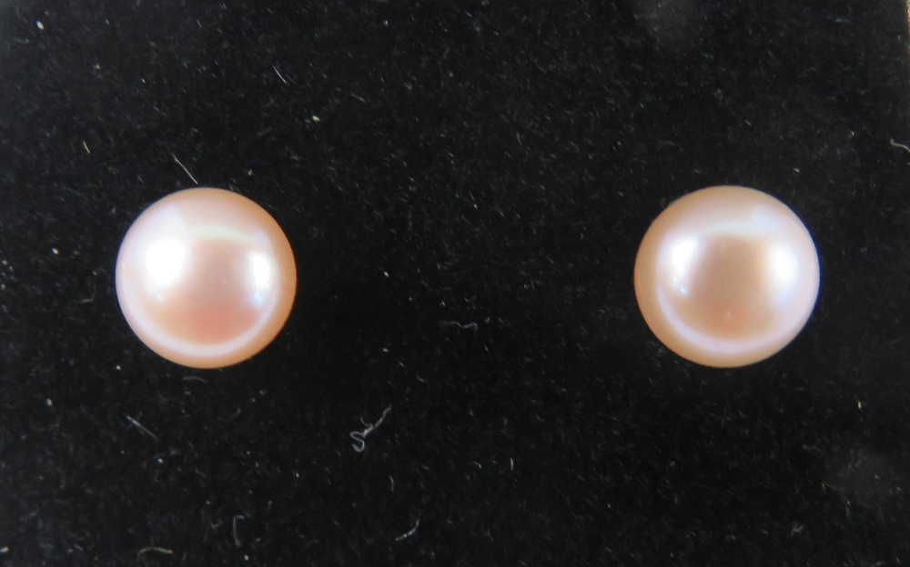 A pair of 9ct and pale pink pearl earrings with butterfly backs, stamped 9ct.