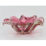 An art glass bowl in the form of a four leave clover, pink ground, having bubble pattern throughout.
