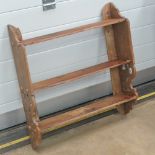 A contemporary walnut wall shelf, 60cm wide.