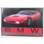 A 1980s BMW M1 'The Ultimate Driving Machine' poster, framed and glazed.